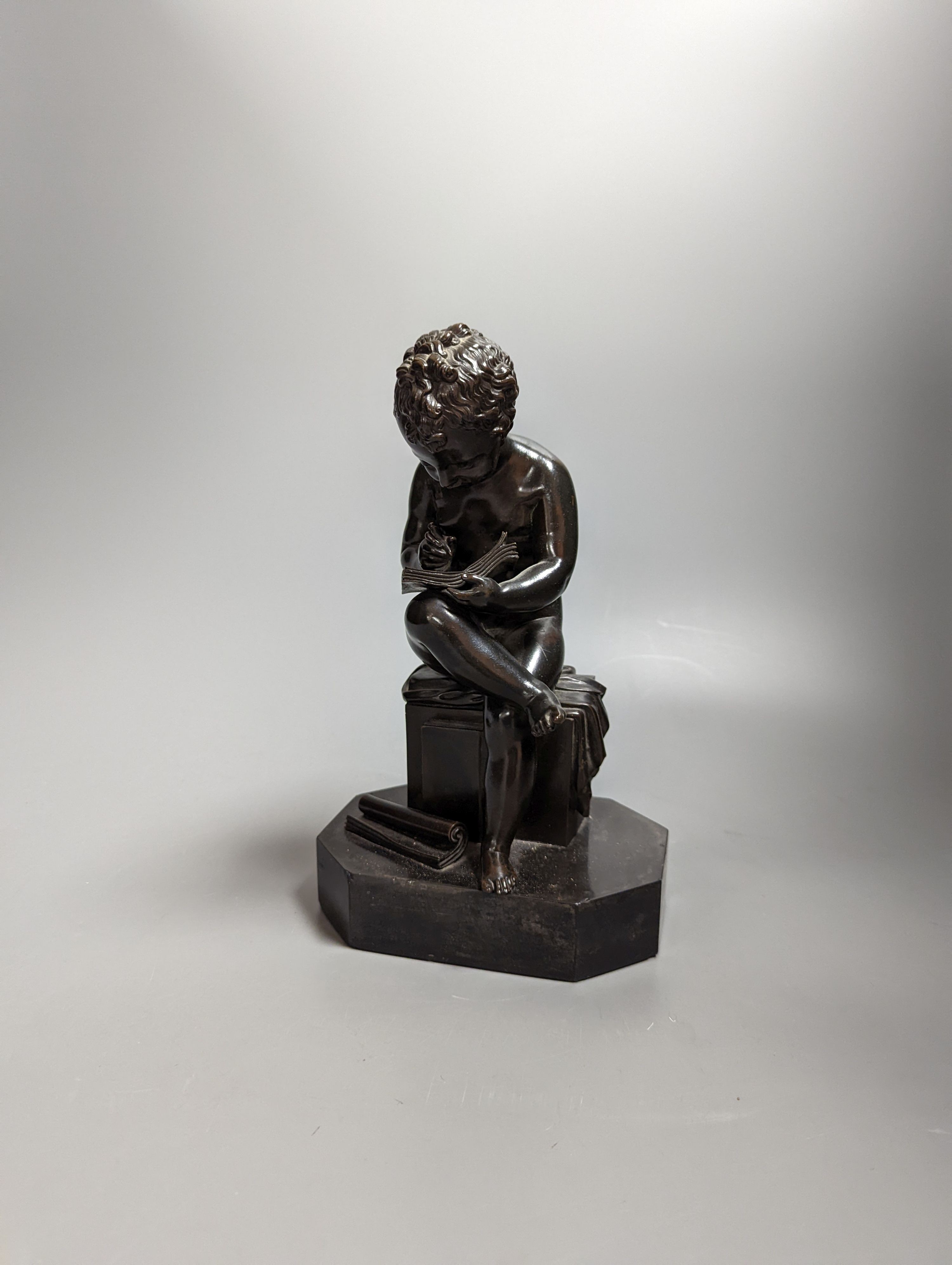 A pair of late 19th century bronze figures of seated putti plotting and writing notes, 26cm